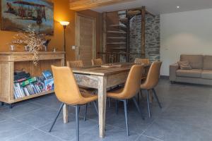 a dining room with a wooden table and chairs at Chalet La Sentinelle in Bellecombe