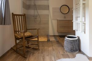 a bathroom with a rocking chair and a shower at Chalet La Sentinelle in Bellecombe