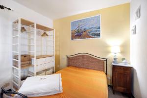 a bedroom with a bed and a painting on the wall at Casa Gelsomino in Imperia