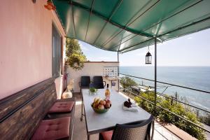 a table with a bowl of fruit on a balcony at Casa Gelsomino in Imperia