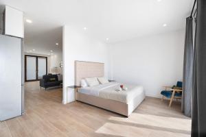 a bedroom with a bed and a living room at Punta del Hidalgo La Laguna in Punta del Hidalgo