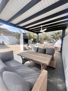 a wooden table and chairs on a patio at Casa Mayra in Los Caparroses