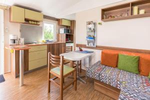 a small kitchen with a table and a bench in a room at Tonis Hütte in Hohenfels