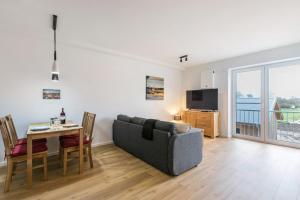 a living room with a couch and a table at Zum Krähenholz Wohnung 9 in Husby