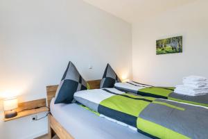two beds sitting next to each other in a bedroom at Zum Krähenholz Wohnung 9 in Husby