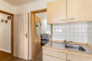 a kitchen with a sink and a couch at Pistenblick in Willingen +109 photos