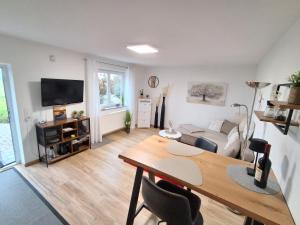 a living room with a table and a couch at Tobel Lounge in Sigmarszell