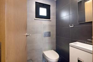 a small bathroom with a toilet and a window at Be Glow Home in Alvor
