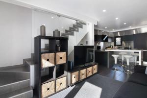a kitchen and living room with a staircase in a house at Be Glow Home in Alvor