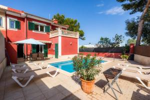 a villa with a swimming pool and a house at Villa Malena in Llucmajor