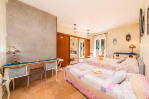 a bedroom with two beds and a desk at Villa Malena in Llucmajor +48 photos