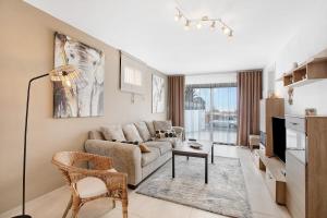 a living room with a couch and a table at Villa La Blanca in Arona