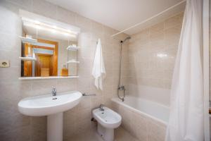 a bathroom with a sink and a toilet and a tub at Marbi in Cala Millor +22 photos