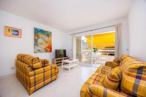a living room with two couches and a television at Marbi in Cala Millor