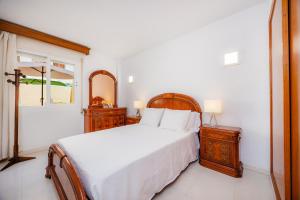 a bedroom with a large bed and a mirror at Marbi in Cala Millor