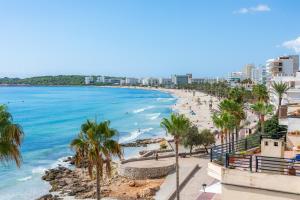 a view of a beach with palm trees and the ocean at Marbi in Cala Millor