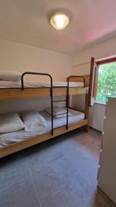 two bunk beds in a room with a window at Appartamenti Con Vista Mozzafiato in Praia a Mare
