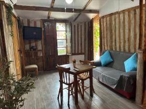a living room with a couch and a table at Cabaña rural piscina privada in Orihuela