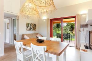 a dining room and living room with a table and chairs at La casa di Debora in San Teodoro