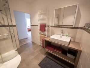 a bathroom with a sink and a shower at Ferienwohnung Pusteblume in Kappelrodeck +15 photos