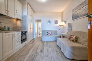 a living room with a couch and a kitchen at Relax Space in Cascabraga +15 photos