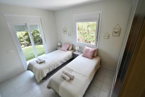 two beds in a room with two windows at Villa with separate apartment in Mijas Costa +31 photos