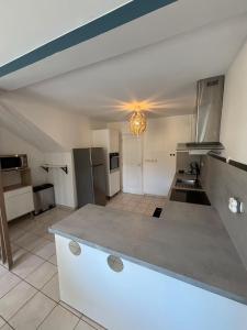 a large kitchen with a counter top in a room at La Villa Yenna in Vergèze