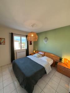 a bedroom with a large bed and a window at La Villa Yenna in Vergèze