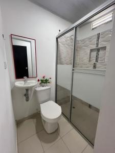 a bathroom with a toilet and a shower and a sink at 306ApartaesudioRomance in Arauca