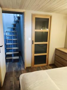 a room with a bed and a spiral staircase at Chalet Les Angles in Les Angles