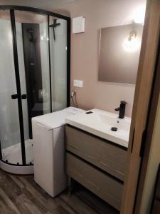 a bathroom with a white sink and a shower at Chalet Les Angles in Les Angles +7 photos