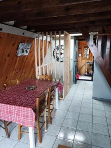 a dining room with a table and wooden ceilings at Chalet Les Angles in Les Angles