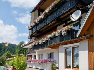 a building with flower boxes on the balconies at Landpension Am Sommerhang in Bad Rippoldsau