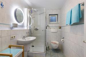 a bathroom with a shower and a sink and a toilet at Preiser in Moos +12 photos