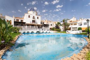 a swimming pool in front of a building at Casa Pedro Piscina in Puerto Marino