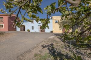 an empty road in front of a white building at Loft Rural Orenetes ideal parejas in Sant Jaume dels Domenys