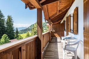 a balcony of a house with a table and chairs at Sabina Dolomites Latsche in Alpe di Siusi