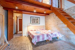 a bedroom with a bed and a staircase at Can Rito in Islas Baleares +34 photos