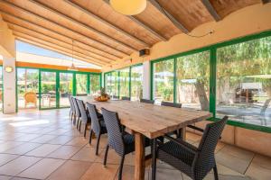 a large dining room with a wooden table and chairs at Can Rito in Islas Baleares