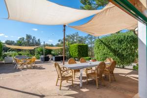 a patio with a table and chairs under a tent at Can Rito in Islas Baleares