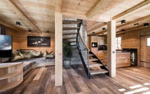a spiral staircase in a room with wooden walls at New Chalet Brunegg Weissenbach in Rio Bianco +26 photos