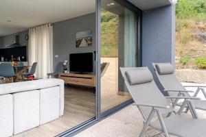 a living room with two chairs and a television at Felicidade in Mondim de Basto