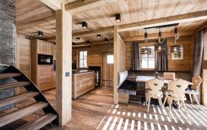 a kitchen and dining room with a table and chairs at New Chalet Brunegg Weissenbach in Rio Bianco