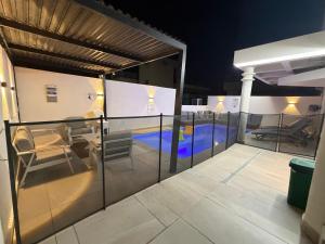 a balcony with a view of a swimming pool at Luxury Duplex With Private Pool in Eilat