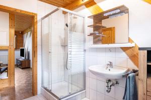 a bathroom with a sink and a shower at Haus Grünblick in Münstertal +22 photos