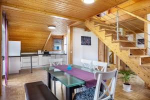 a dining room and kitchen with a wooden ceiling at Haus Grünblick in Münstertal