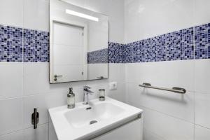 a white bathroom with a sink and a mirror at Bonamar in Arona +18 photos
