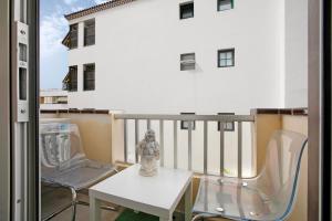 a balcony with a table and chairs on a building at Bonamar in Arona