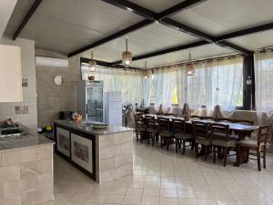 a kitchen and dining room with a table and chairs at Villa Forino Ragusa in Santa Maria del Focallo +29 photos
