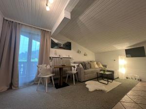 a living room with a couch and a table at Wolfbachgut - Ferienwohnung 5 in Taxenbach